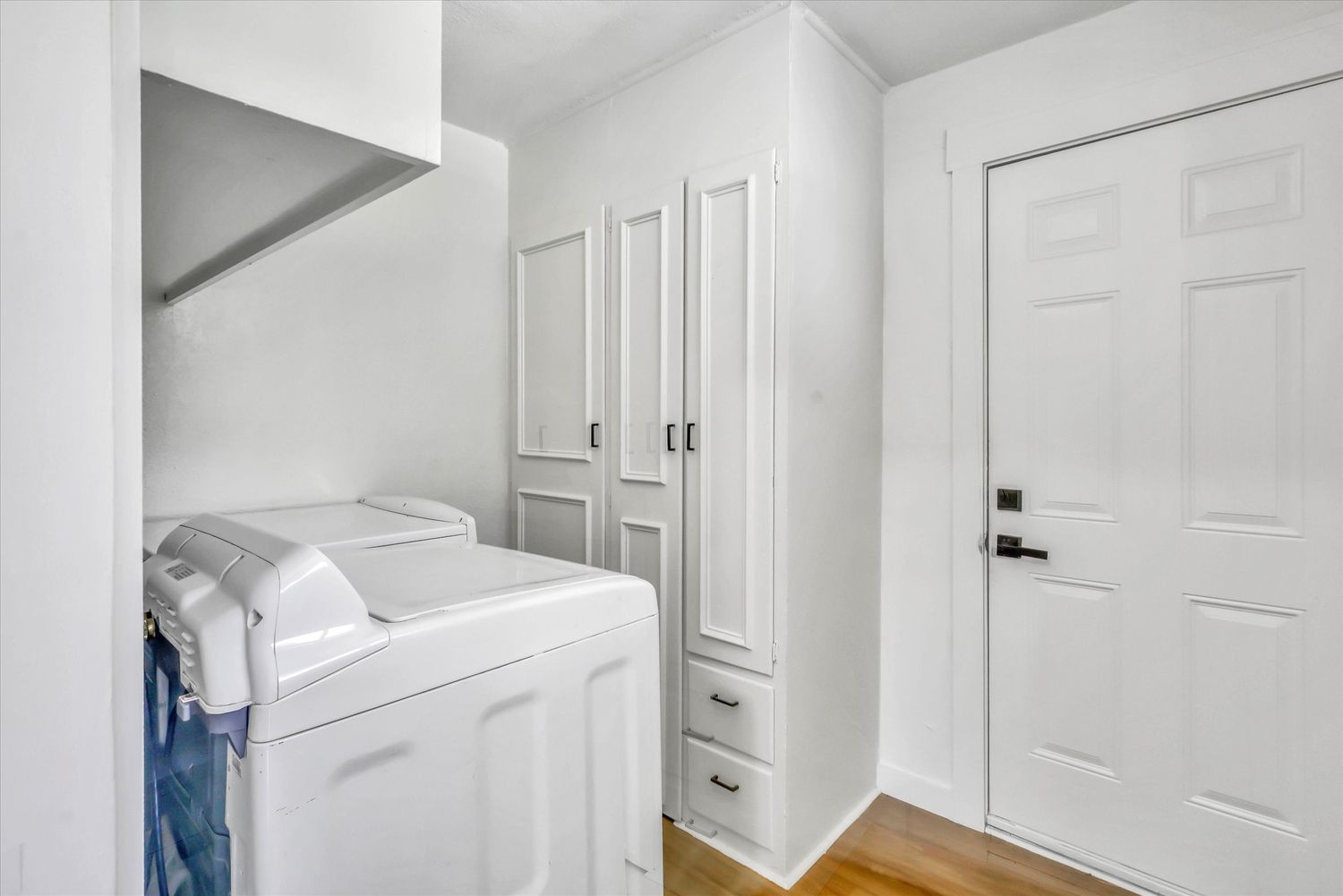 Interior laundry room with storage cabinetry